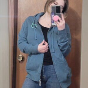 Peloton blue zip up jacket size medium with rose on the back NWT